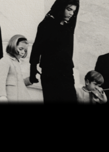 Jacqueline Kennedy holds the hands of her children, Caroline and John Jr. on the day of President Kennedy's funeral.